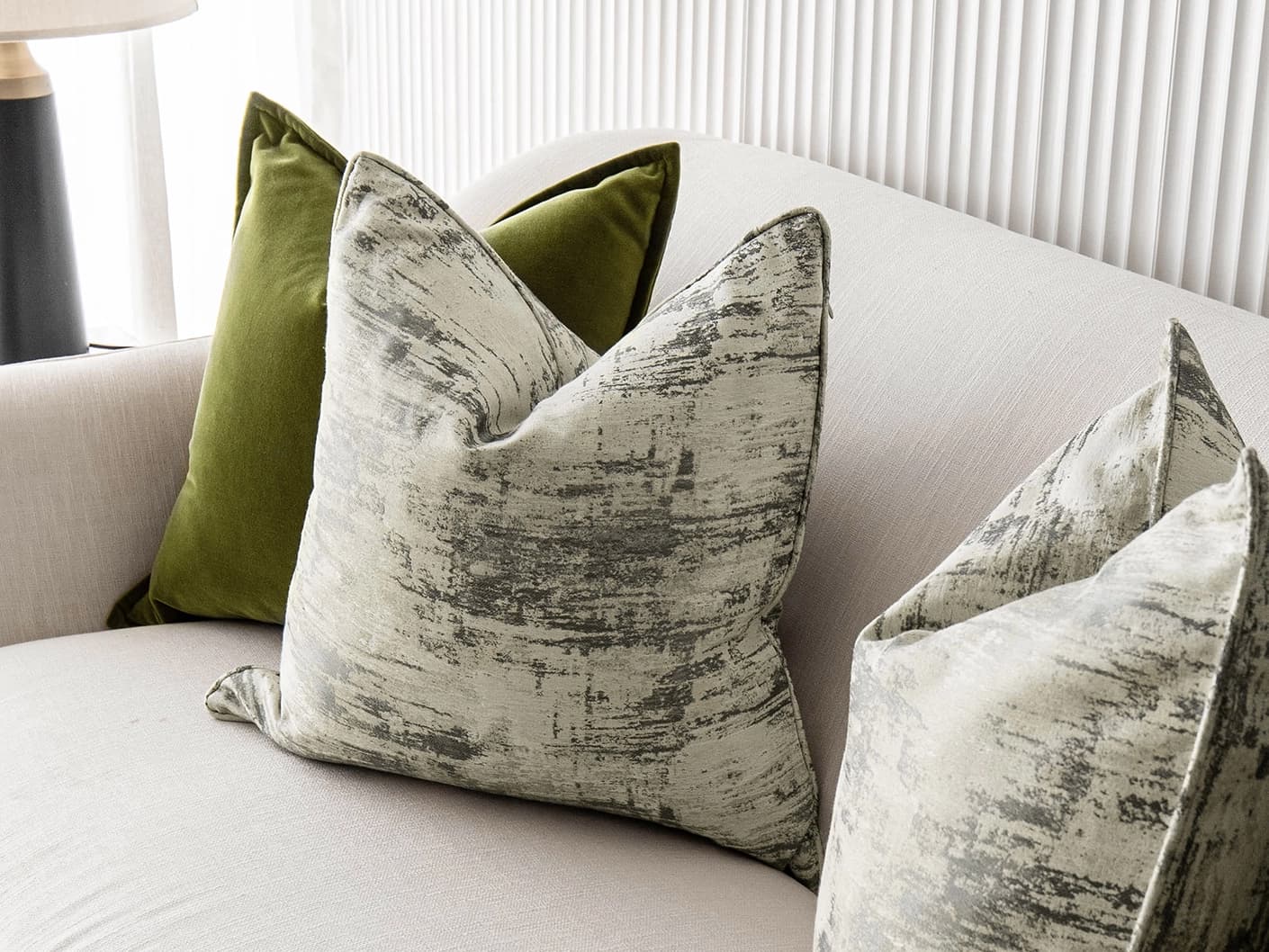 Omarie Bundle bundle cushions in green, grey and white, shown in a lifestyle front view