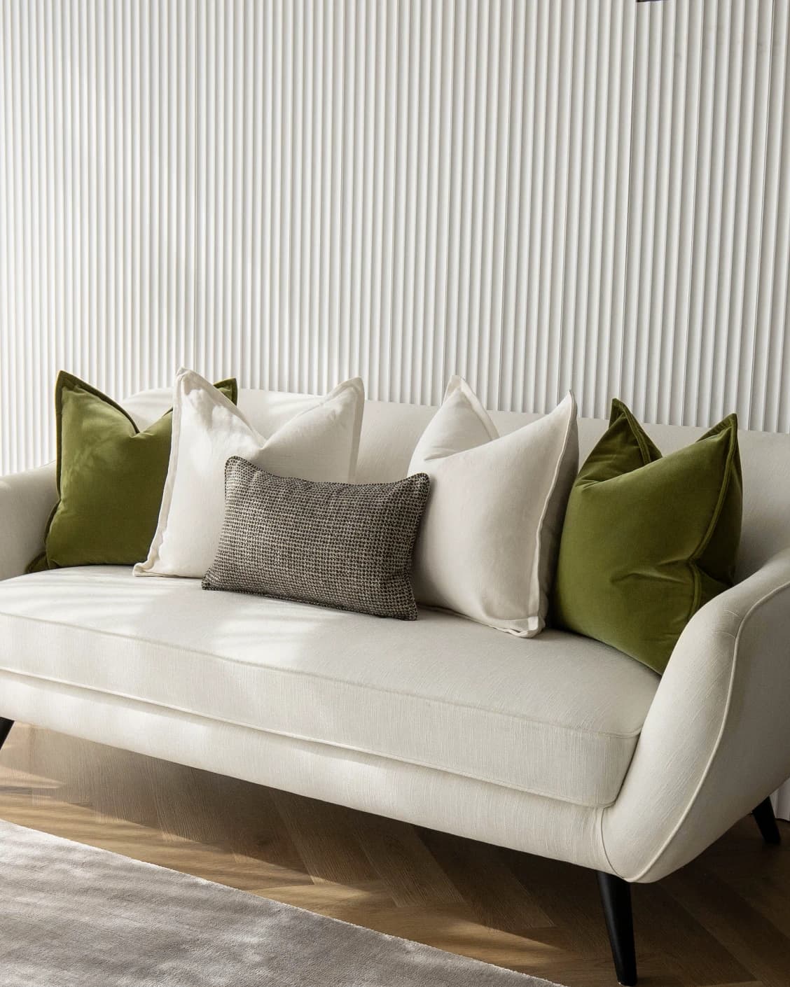 Oona Bundle cushion in white, green and black, shown in a lifestyle front view as image 2