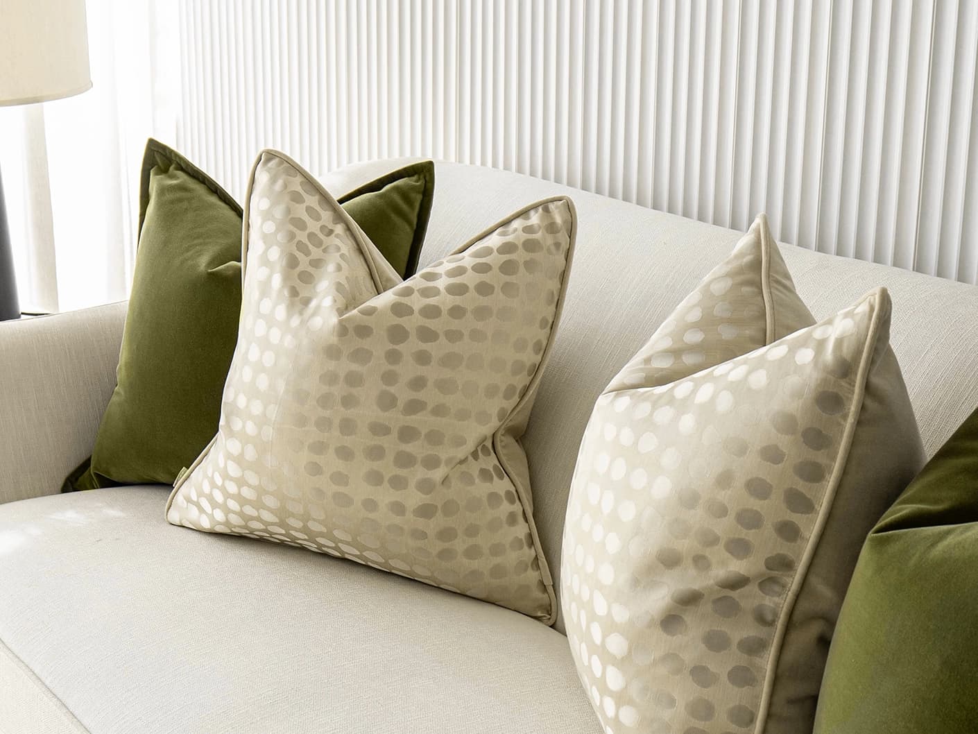 Orion Bundle bundle cushions in green, beige and gold, shown in a lifestyle front view
