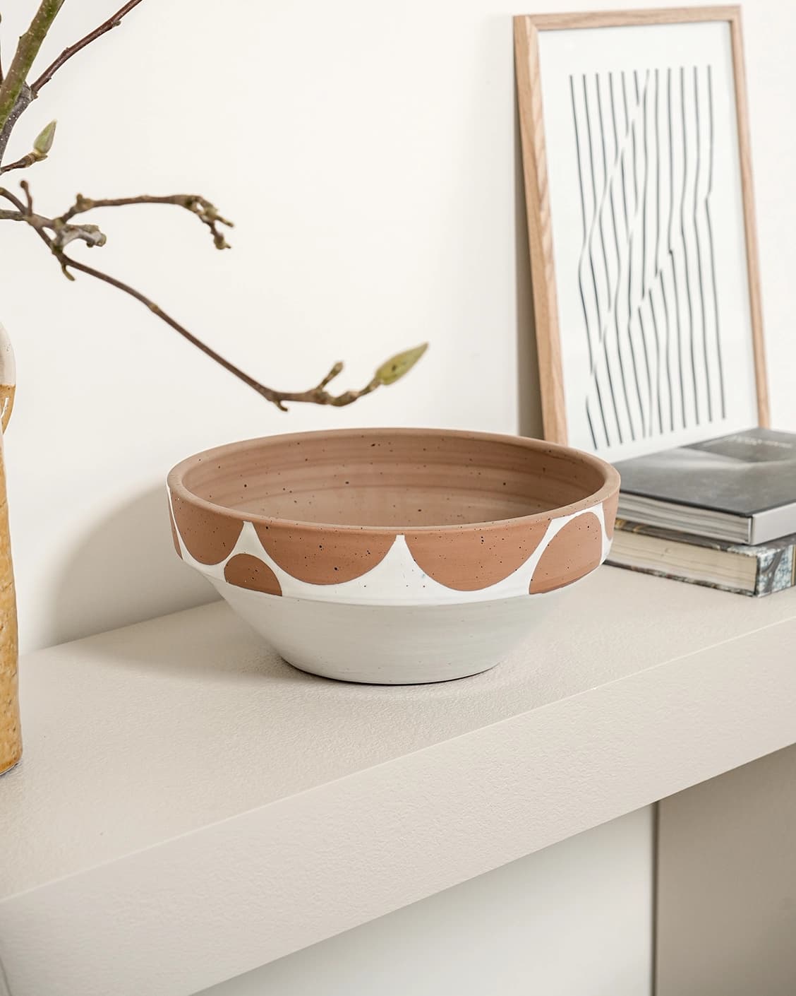 Oris Terra bowls in soft ivory, beige and white, shown in a lifestyle left view