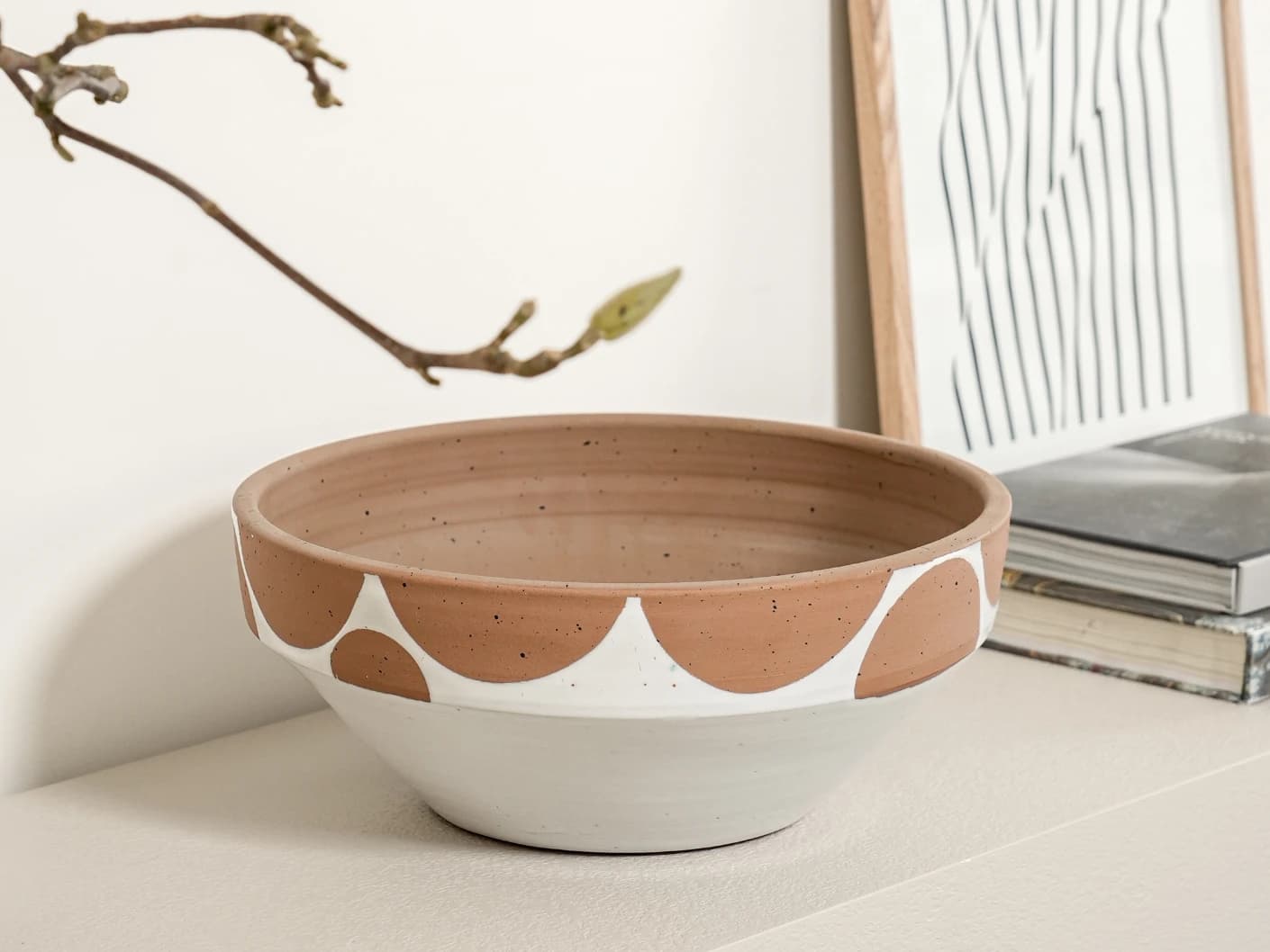 Oris Terra bowls in soft ivory, beige and white, shown in a lifestyle left view