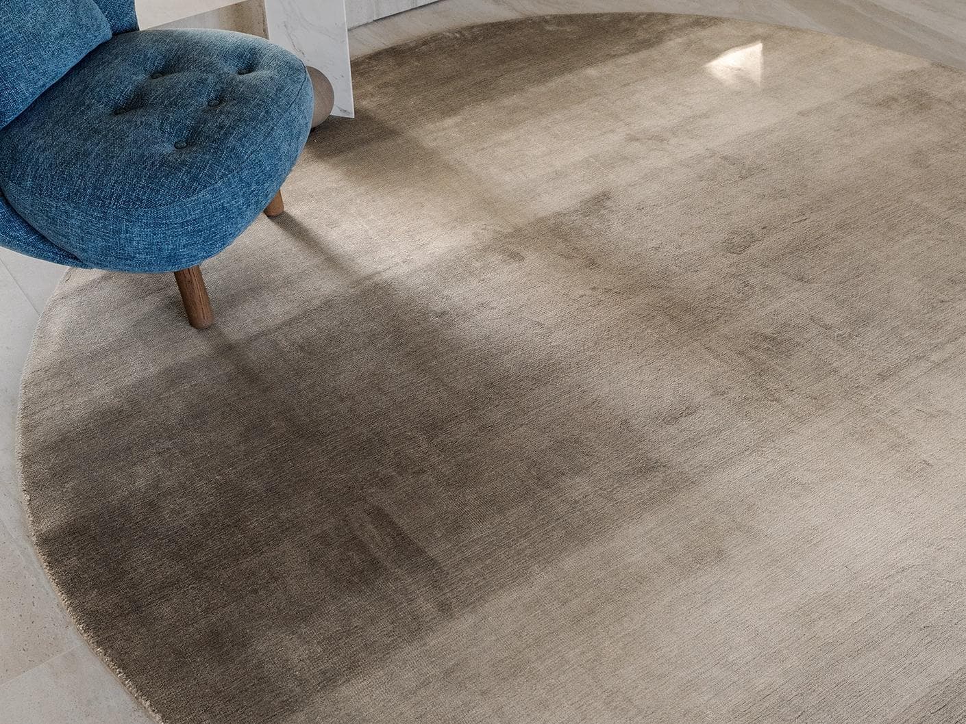 Oscar Ashton carpets in beige, shown in a lifestyle close-up top view as image 1