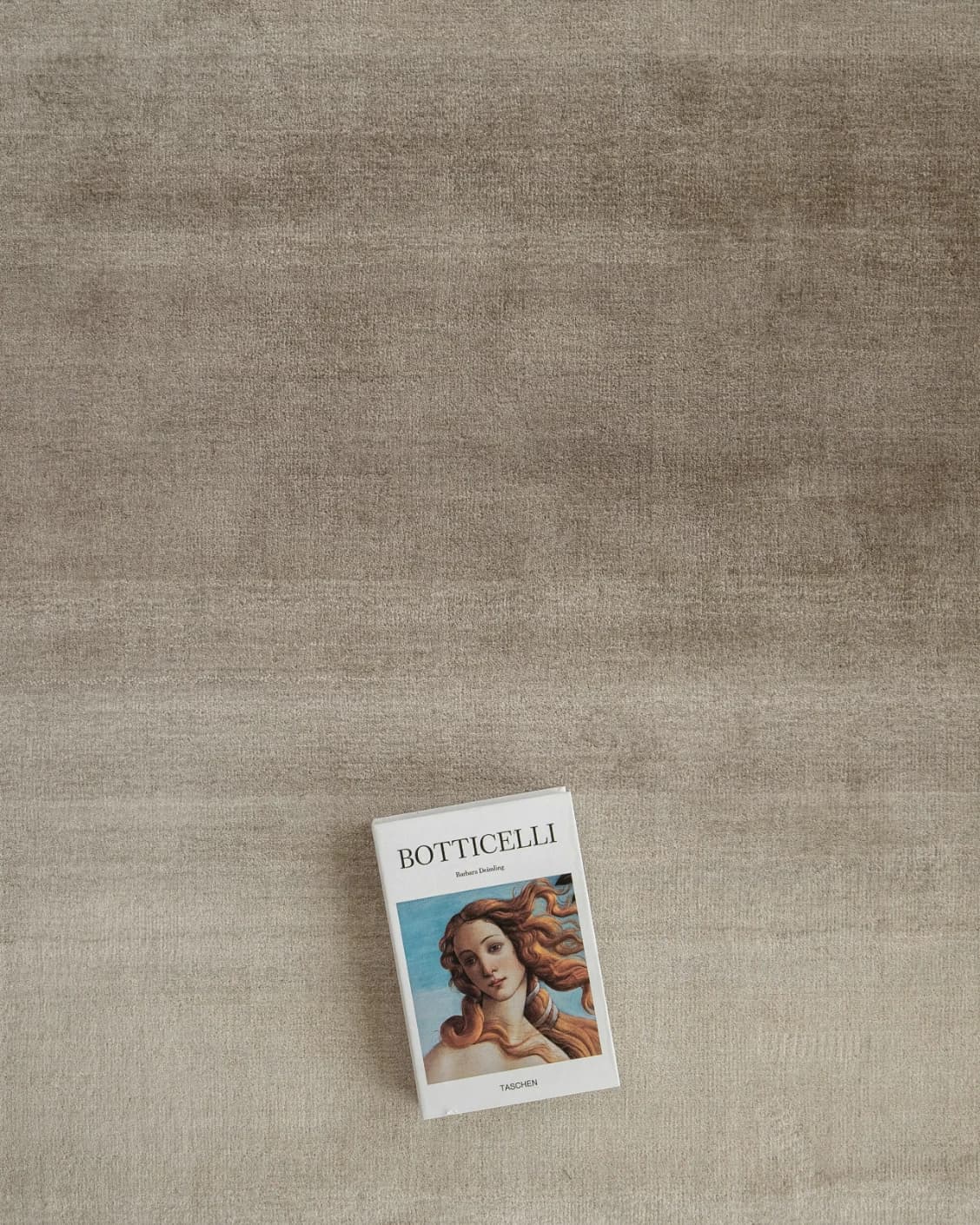 Oscar Ashton carpet in beige, shown in a lifestyle top view as image 9