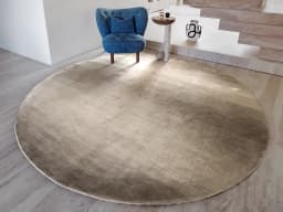 Oscar Ashton Round carpet in beige, shown in a lifestyle front view
