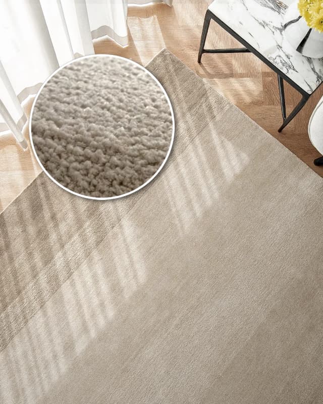 Oscar Dune carpet in beige, shown in a lifestyle top view as image 2