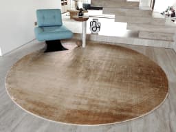 Oscar Sandy Round carpet in sandy and beige, shown in a lifestyle front view