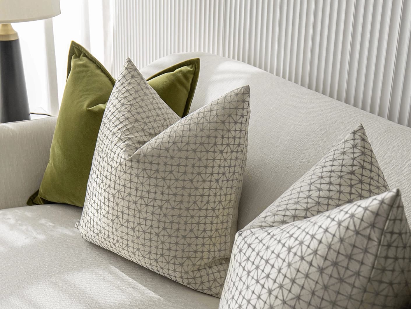 Otto Bundle bundle cushions in silver, green and white, shown in a lifestyle front view