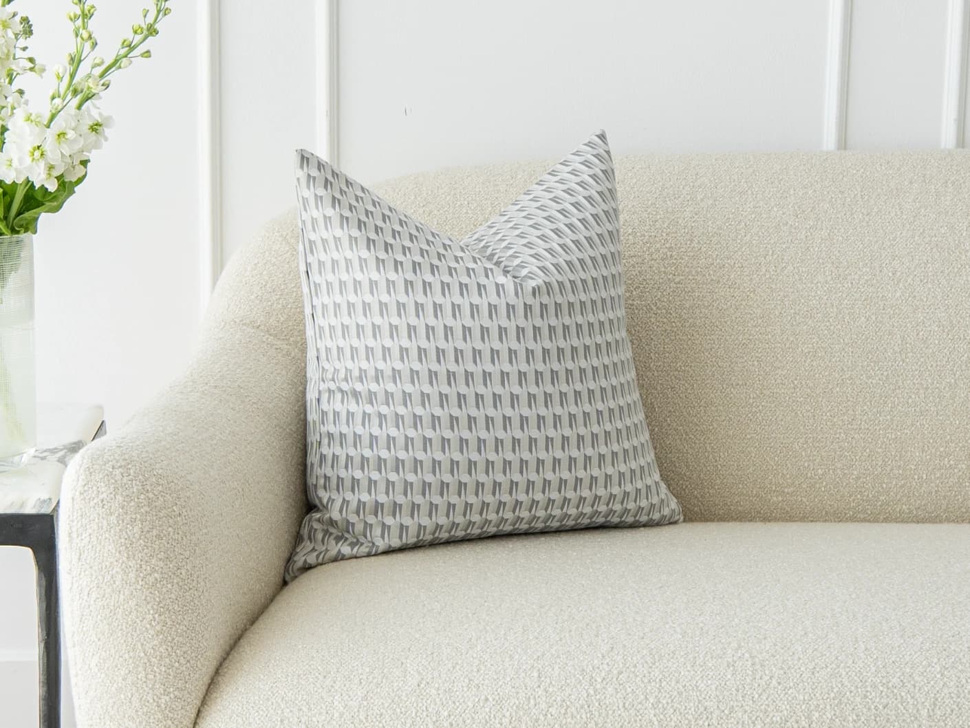 Paul Canova single cushions in grey, shown in a lifestyle front view