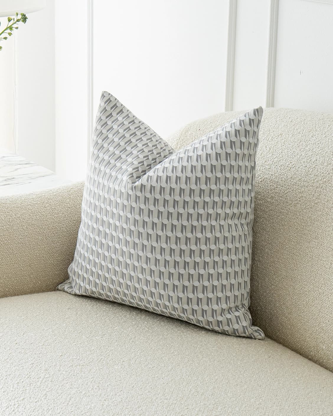 Paul Canova cushion in grey, shown in a lifestyle front view as image 2