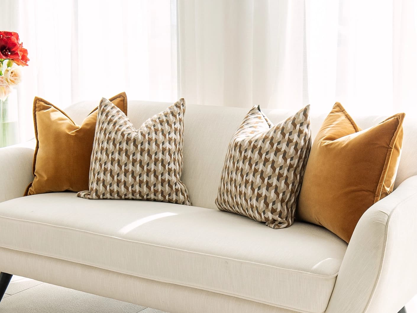 Phoebe Bundle bundle cushions in orange, shown in a lifestyle front view