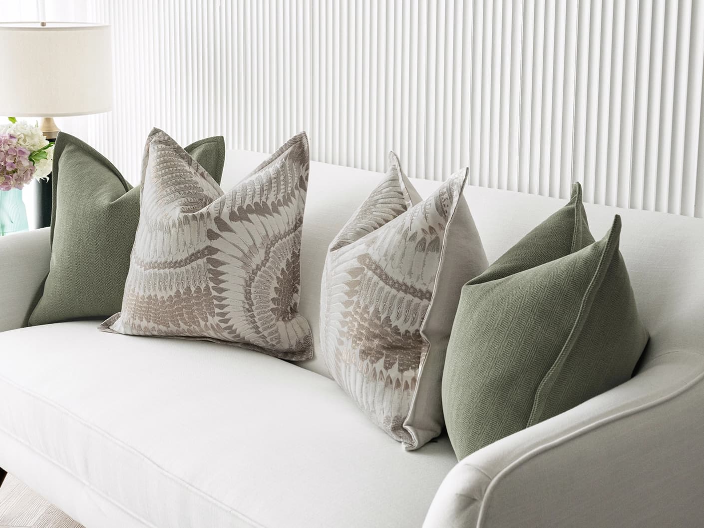 Quentin Bundle bundle cushions in green, brown and grey, shown in a lifestyle front view