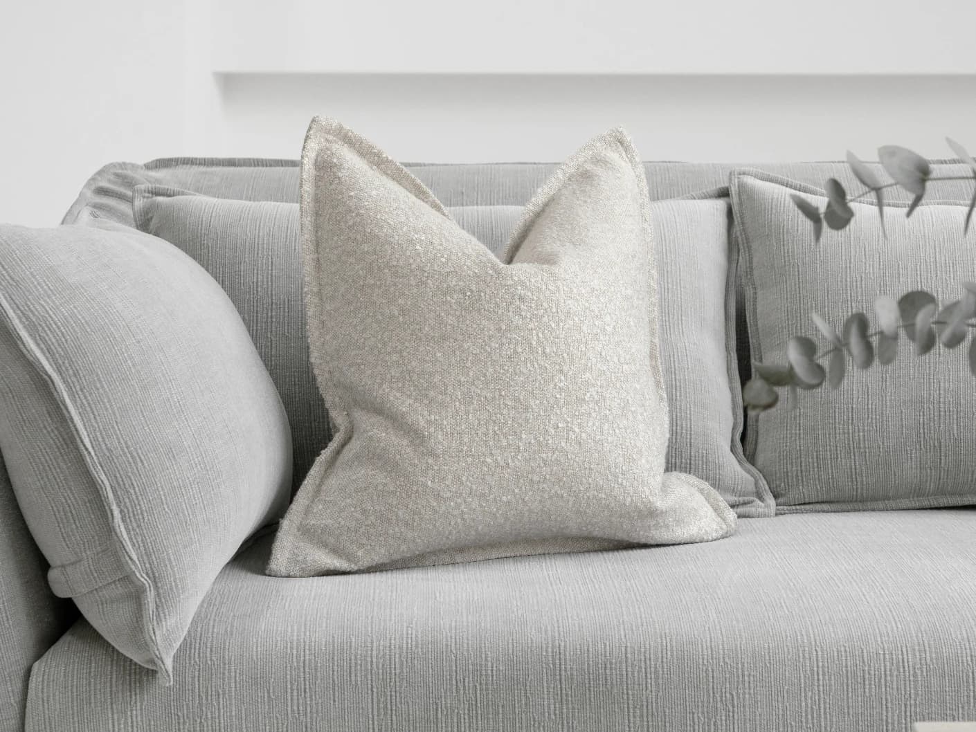 Quinn Shale single cushions in cream and beige, shown in a lifestyle front view