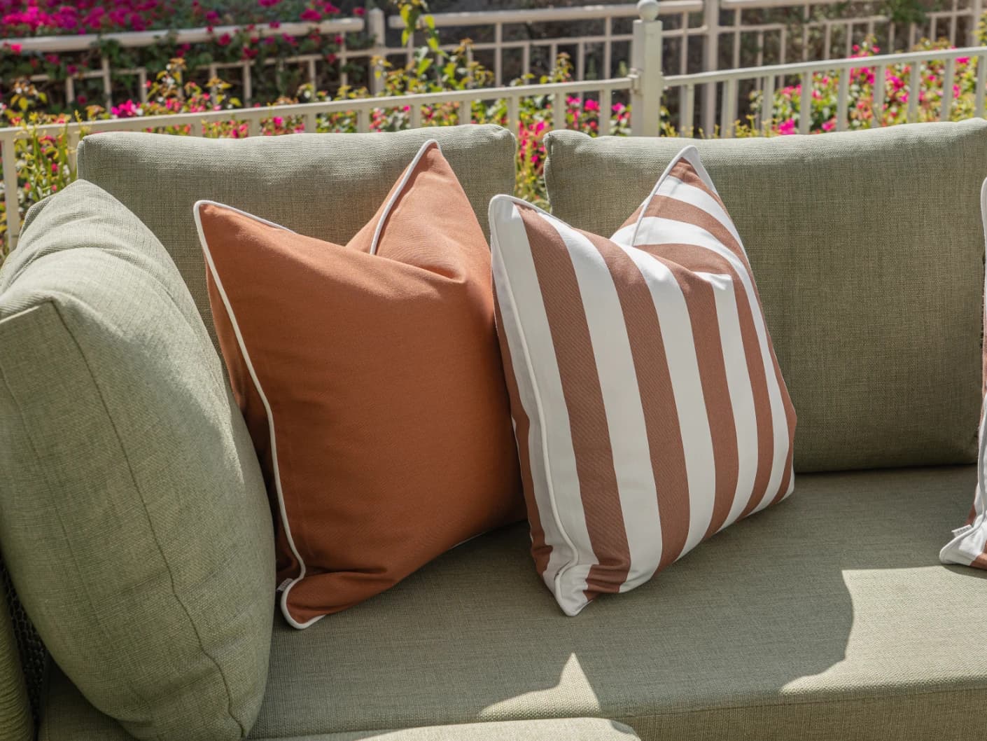 Raha Bundle bundle cushions in rust, shown in a lifestyle front view