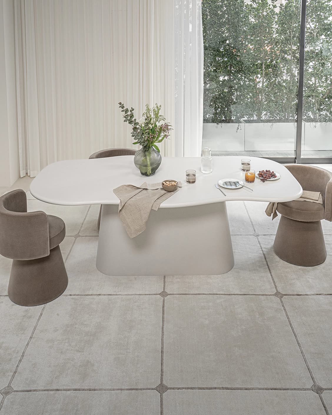 Ravenna dining table in soft ivory, stone and ivory, shown in a lifestyle front view as image 2