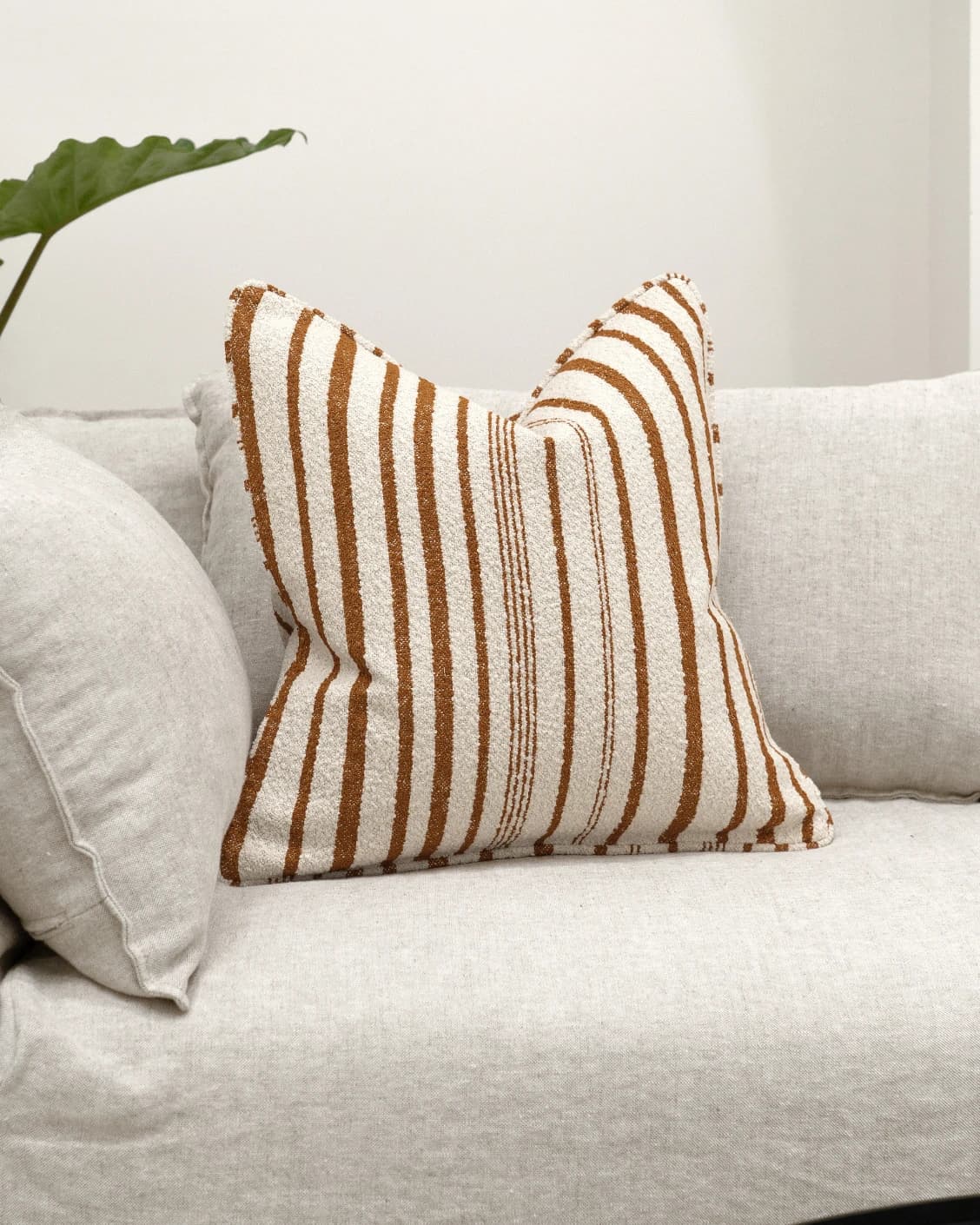 Raya Hodler cushion in ivory, shown in a lifestyle front view as image 2