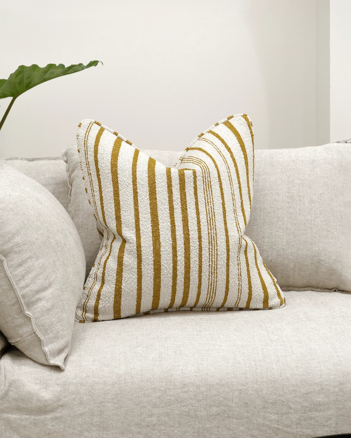 Raya Klimt cushion in ivory, shown in a lifestyle front view as image 2
