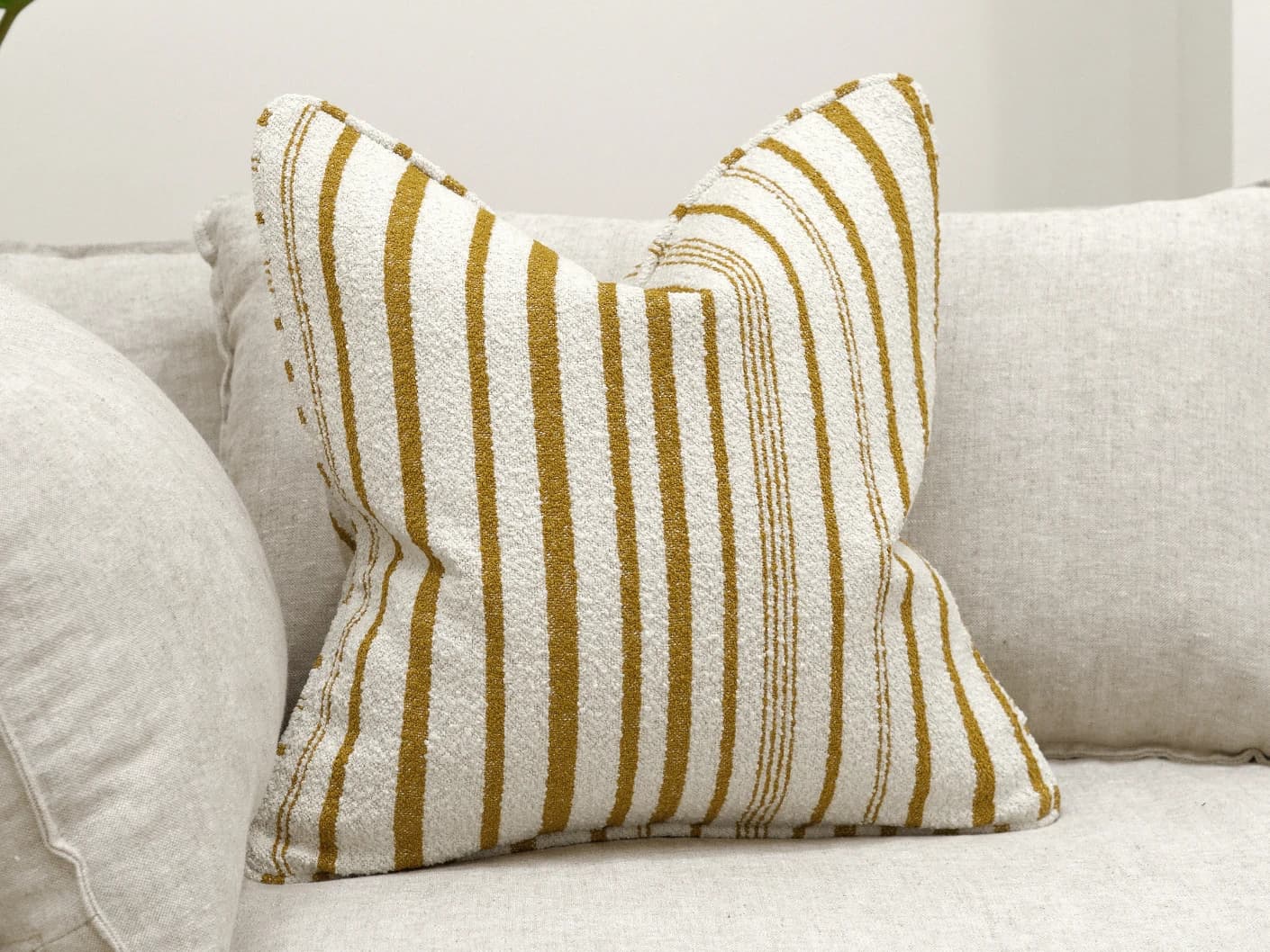 Raya Klimt single cushions in ivory, shown in a lifestyle front view