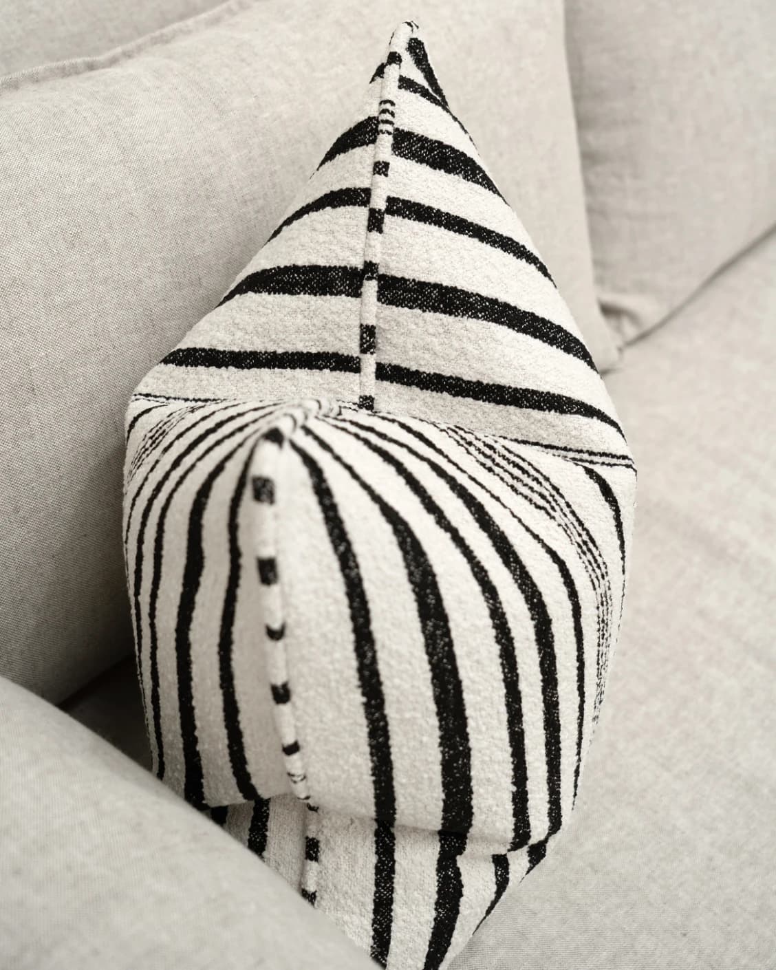 Raya Steele cushion in ivory and charcoal, shown in a lifestyle top view as image 5
