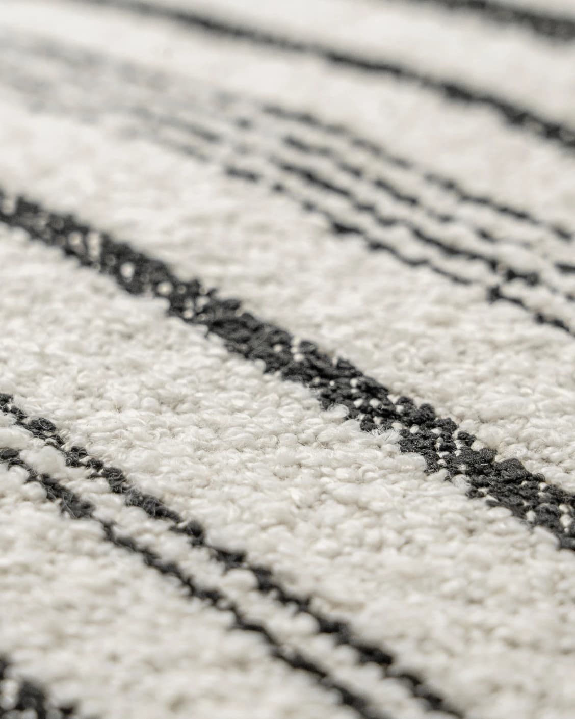 Raya Steele cushion in ivory and charcoal, shown in a product close-up as image 6