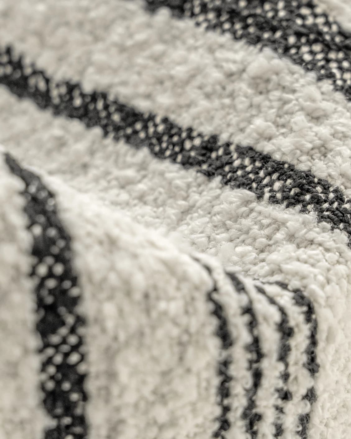 Raya Steele cushion in ivory and charcoal, shown in a product close-up as image 8