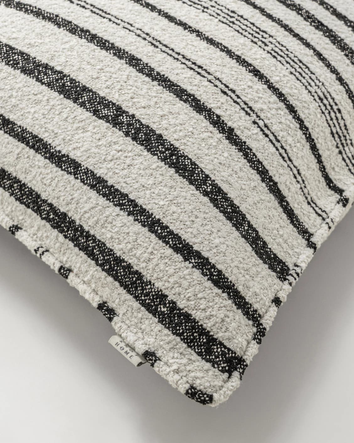 Raya Steele cushion in ivory and charcoal, shown in a product top view as image 10