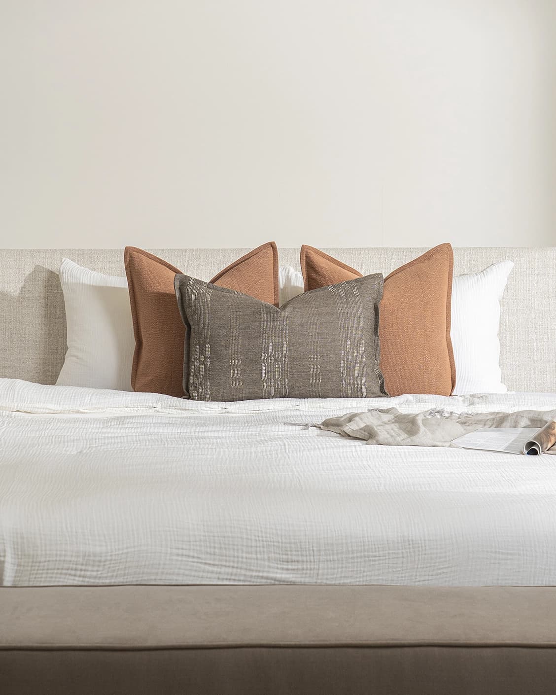 Rayan Bundle cushion in rust, shown in a lifestyle front view as image 2