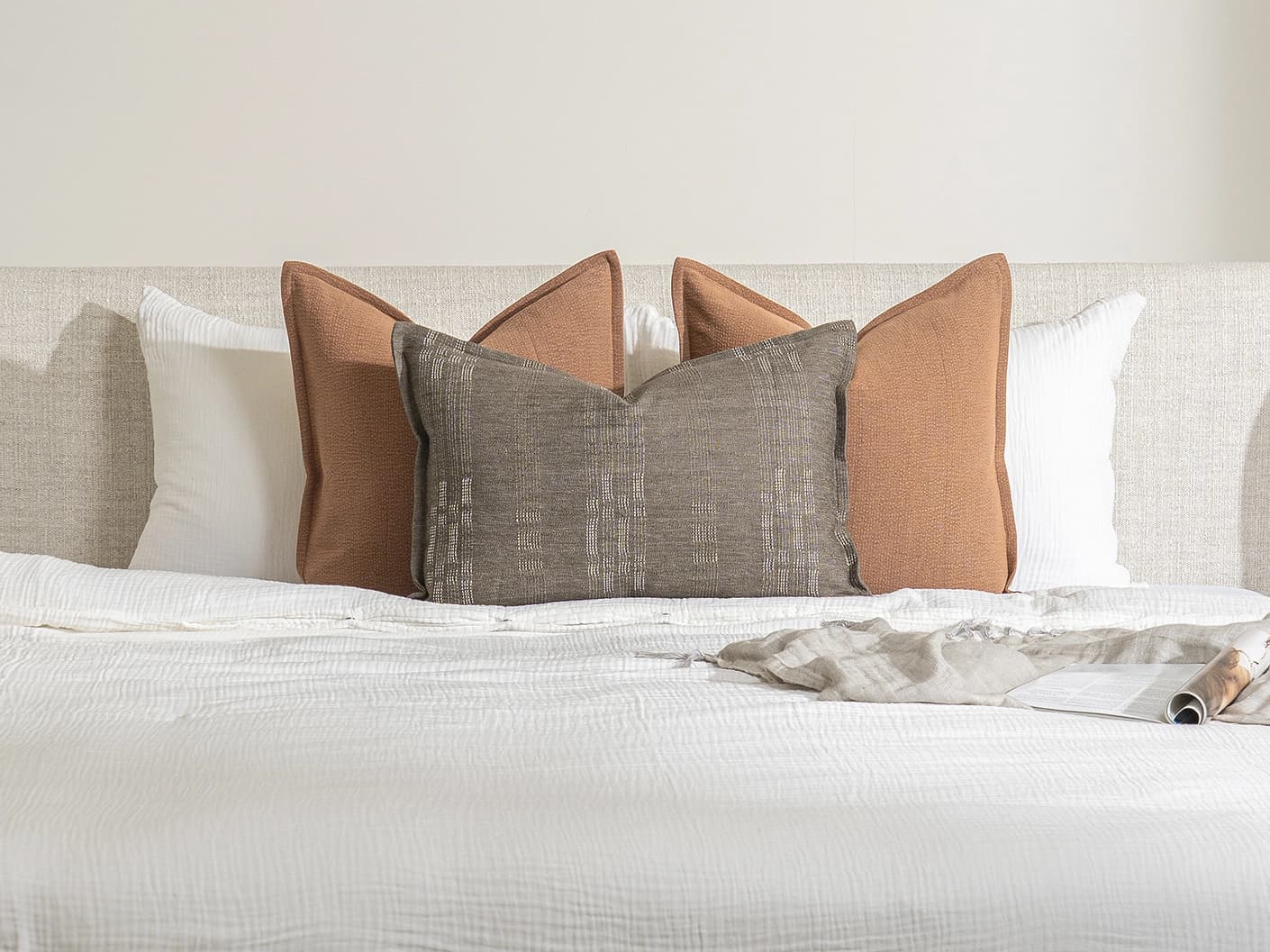 Rayan Bundle bundle cushions in rust, shown in a lifestyle front view