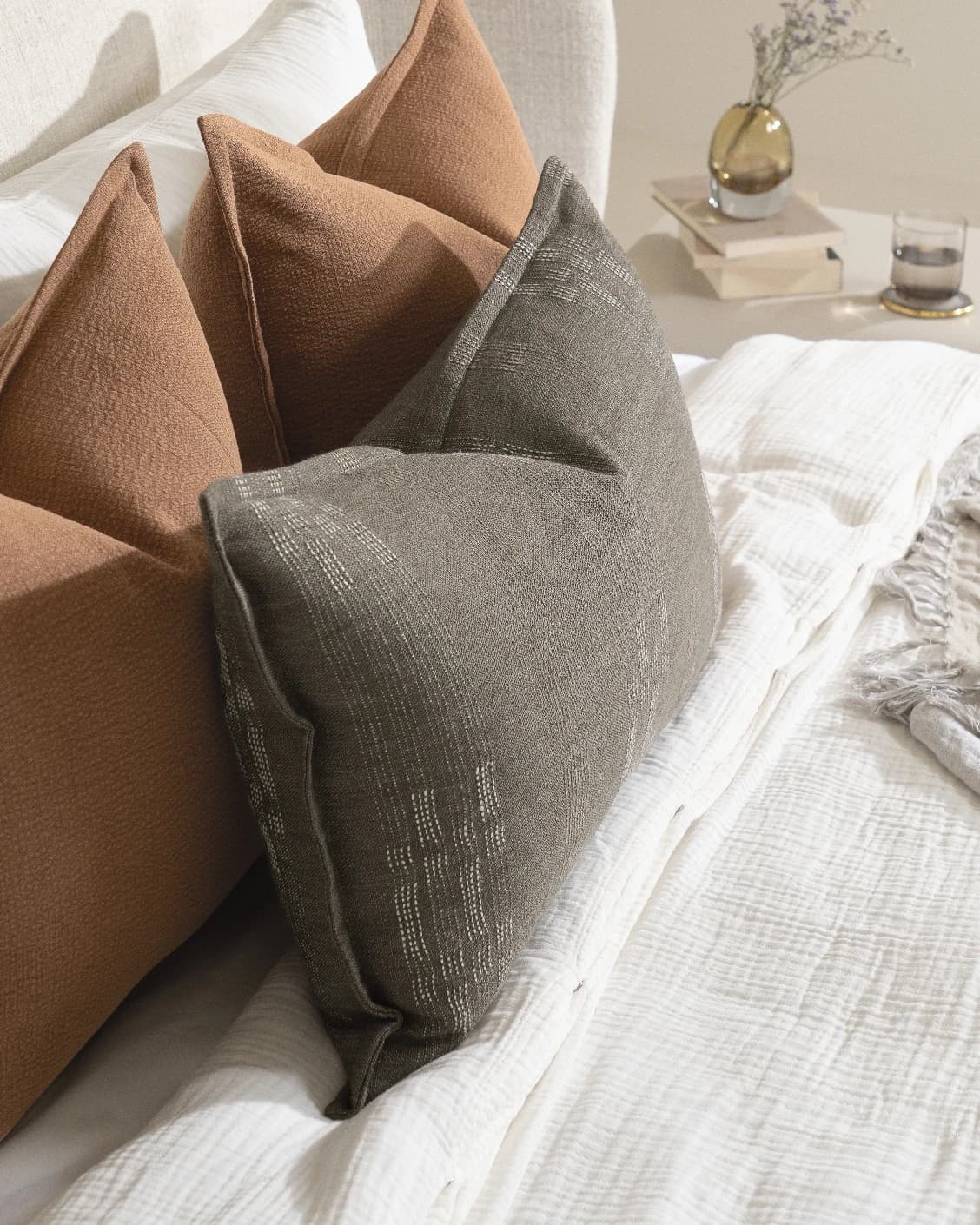 Rayan Bundle cushion in rust, shown in a lifestyle left view as image 7