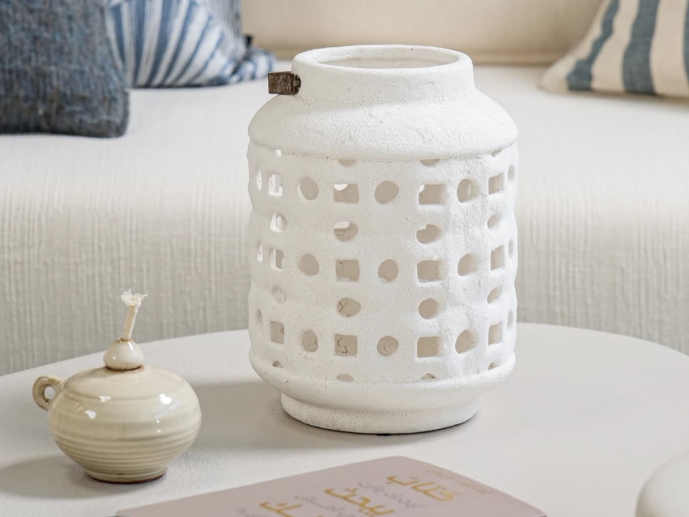Reba Terra candle holders in soft ivory and ivory, shown in a lifestyle front view
