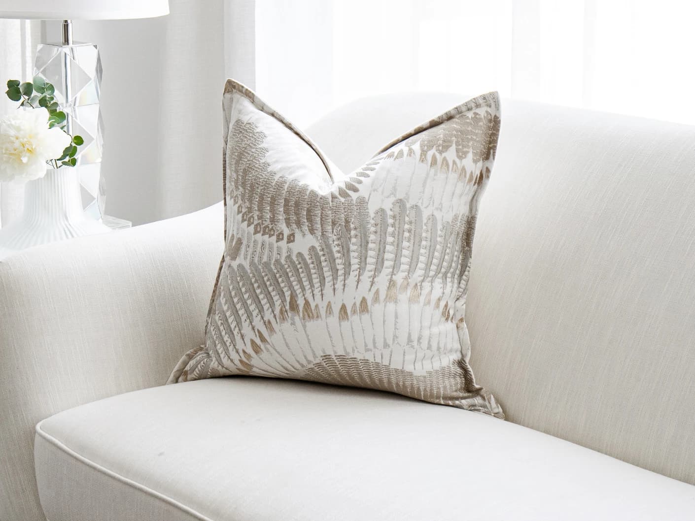 Reesha Bianca single cushions in brown and grey, shown in a lifestyle front view