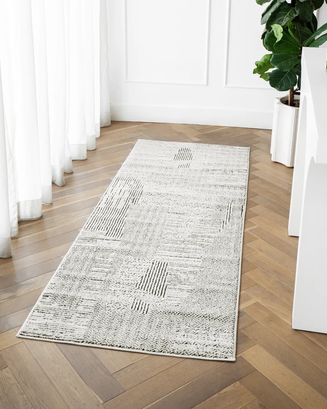 Renzo Dusty Runners carpet in black and white, shown in a lifestyle front view as image 2