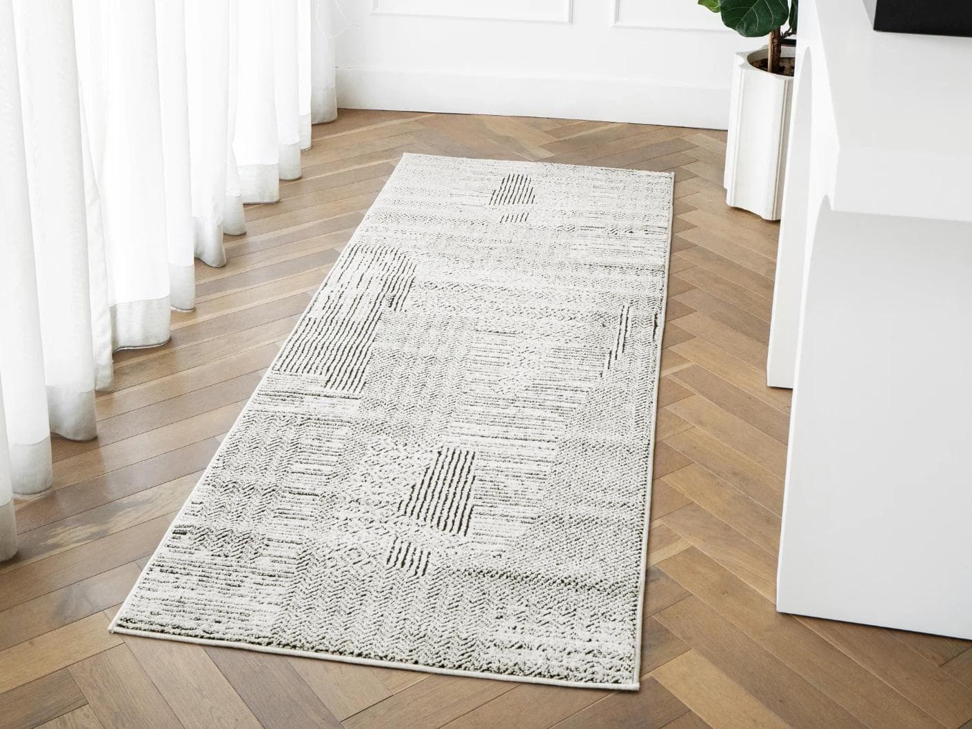 Renzo Dusty carpets in black and white, shown in a lifestyle front view as image 1