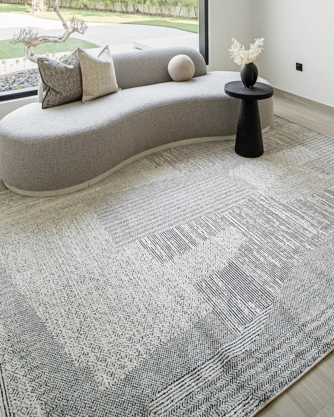 Renzo Dusty carpet in black and white, shown in a lifestyle left view as image 5