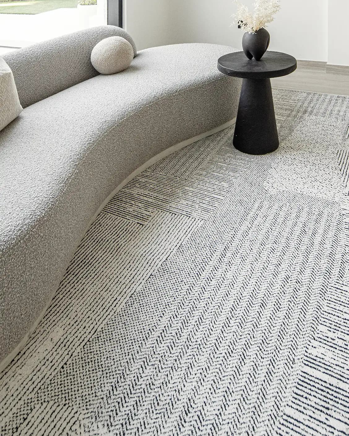 Renzo Dusty carpet in black and white, shown in a lifestyle left view as image 6