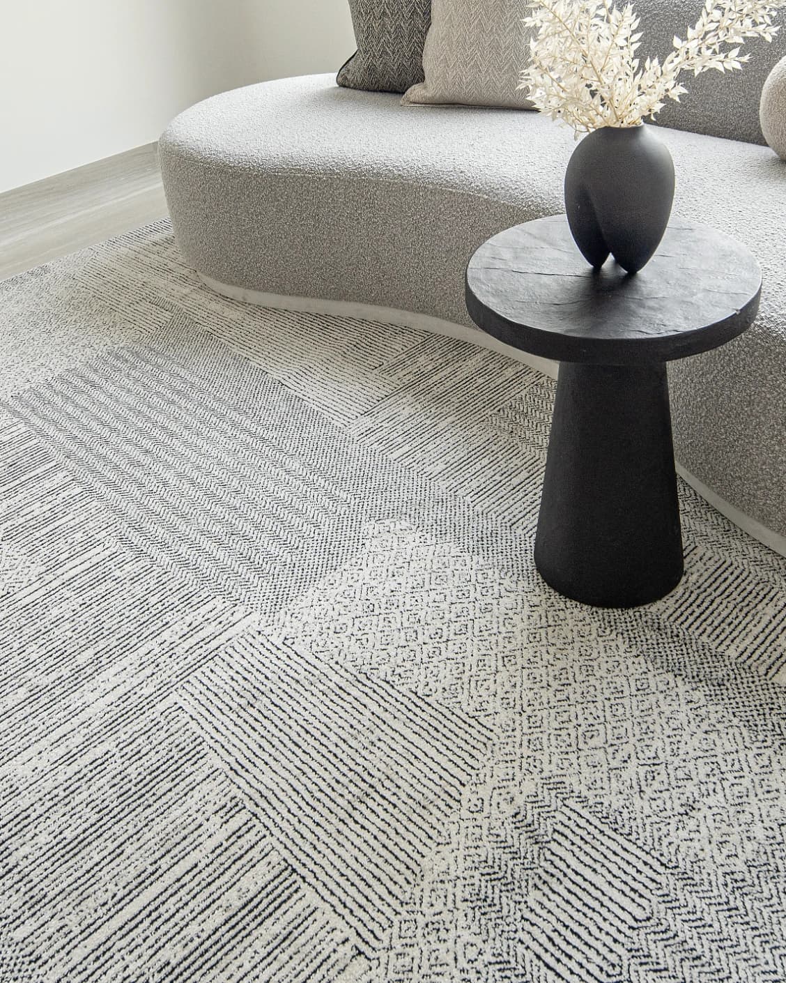 Renzo Dusty carpet in black and white, shown in a lifestyle right view as image 7