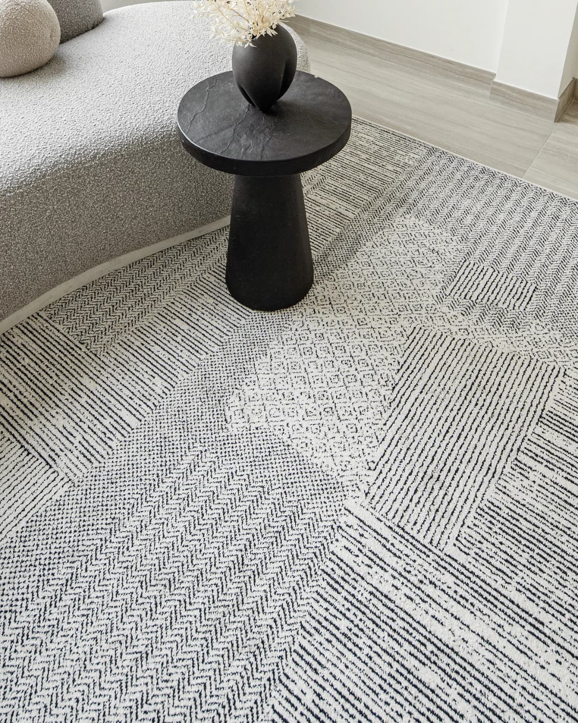 Renzo Dusty carpet in black and white, shown in a lifestyle top view as image 9