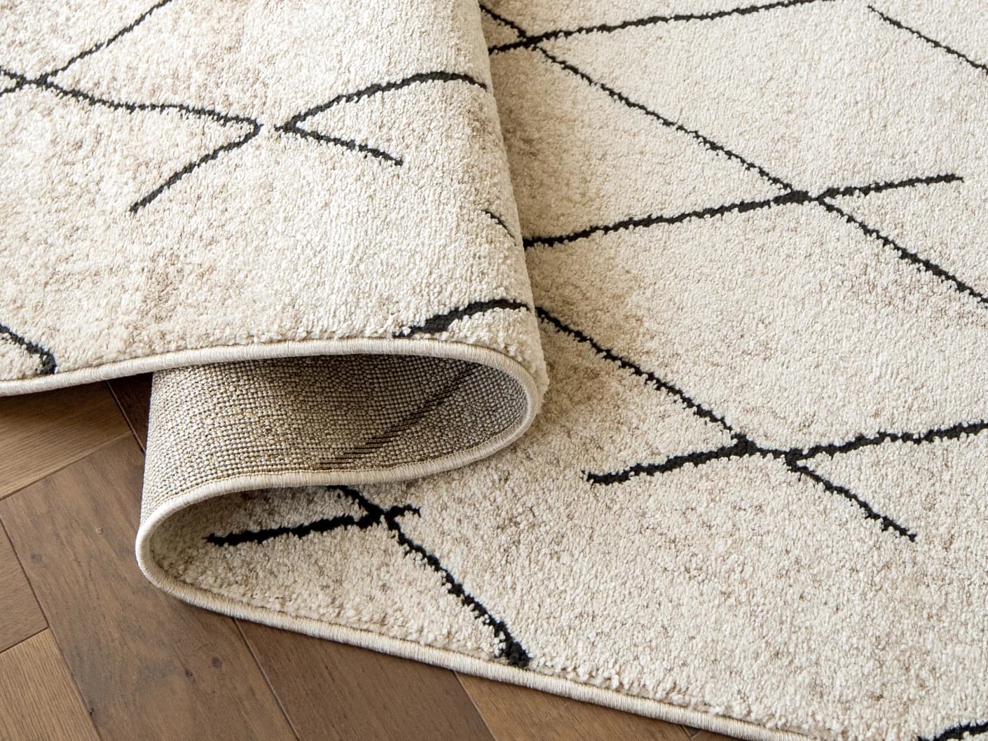 Renzo Ebony Runners carpets in ebony and beige, shown in a product close-up view