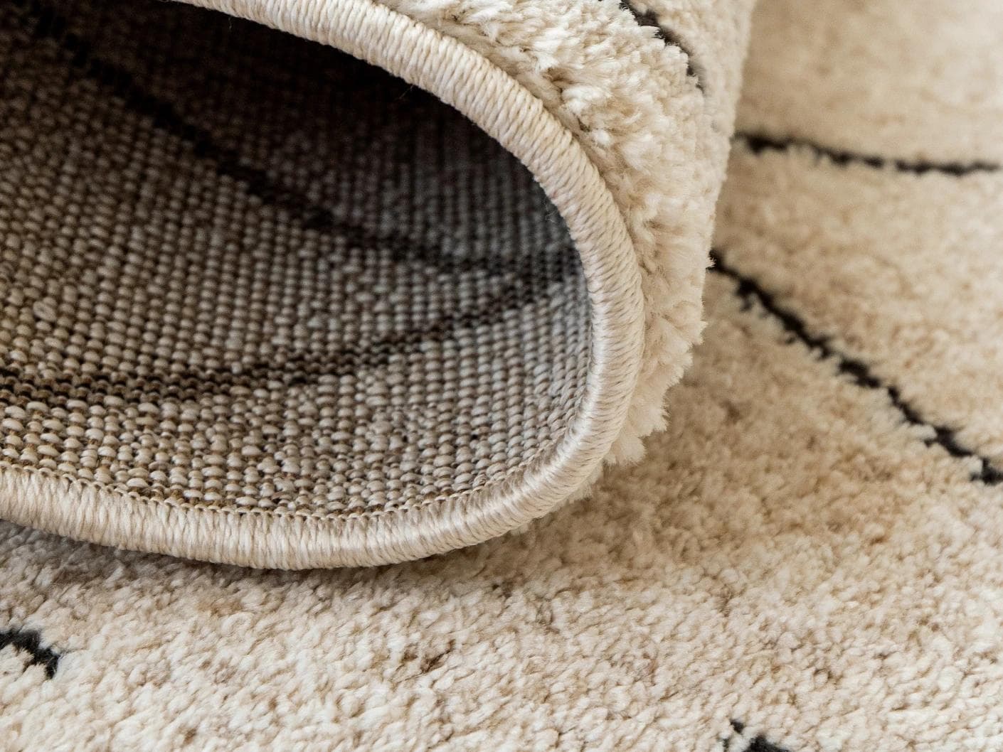 Renzo Ebony carpet in beige, shown in a product close-up as image 11