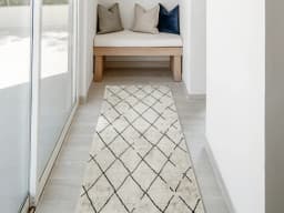 Renzo Ebony Runners carpet in beige, shown in a lifestyle front view