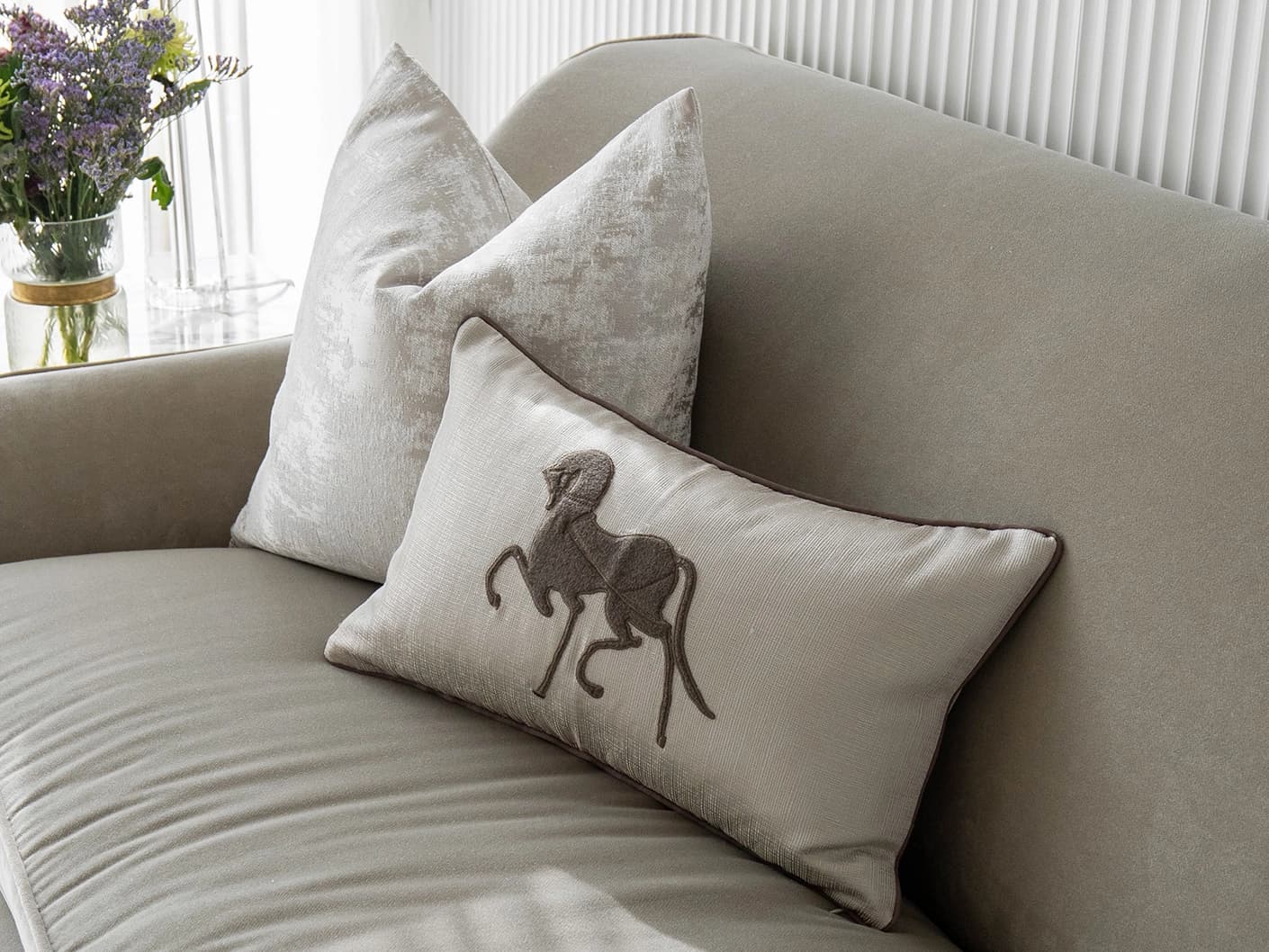 Rhenzy Bundle bundle cushions in silver, grey, brown and beige, shown in a lifestyle front view