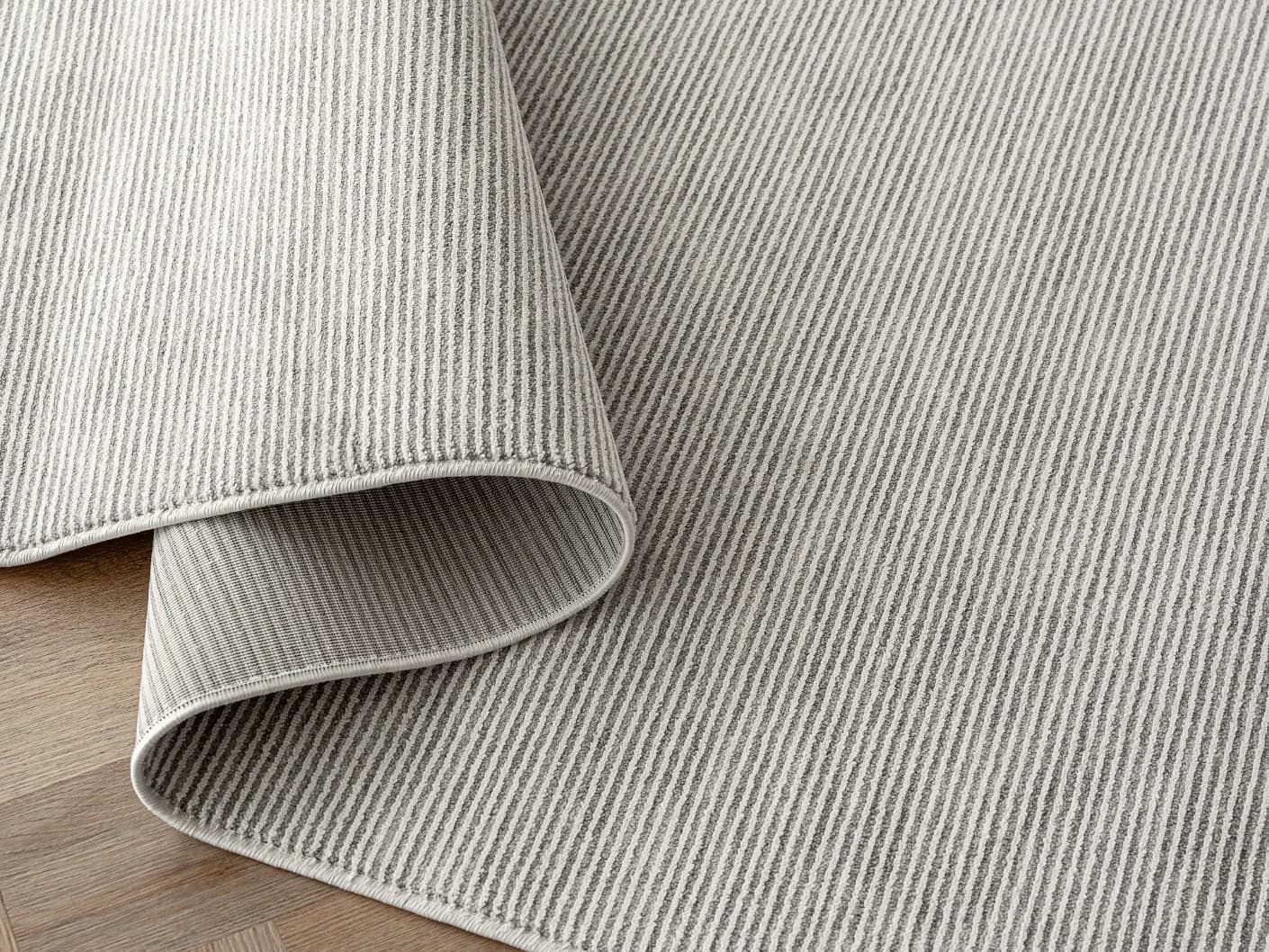 Rik Dune Round carpets in dune and grey, shown in a product close-up view