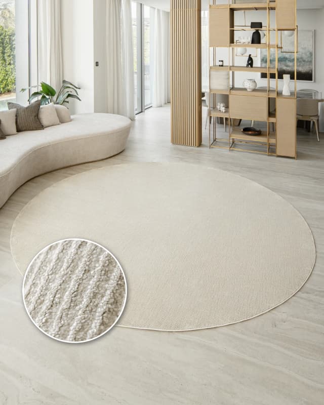 Rik Sandy Round carpet in beige, shown in a lifestyle front view