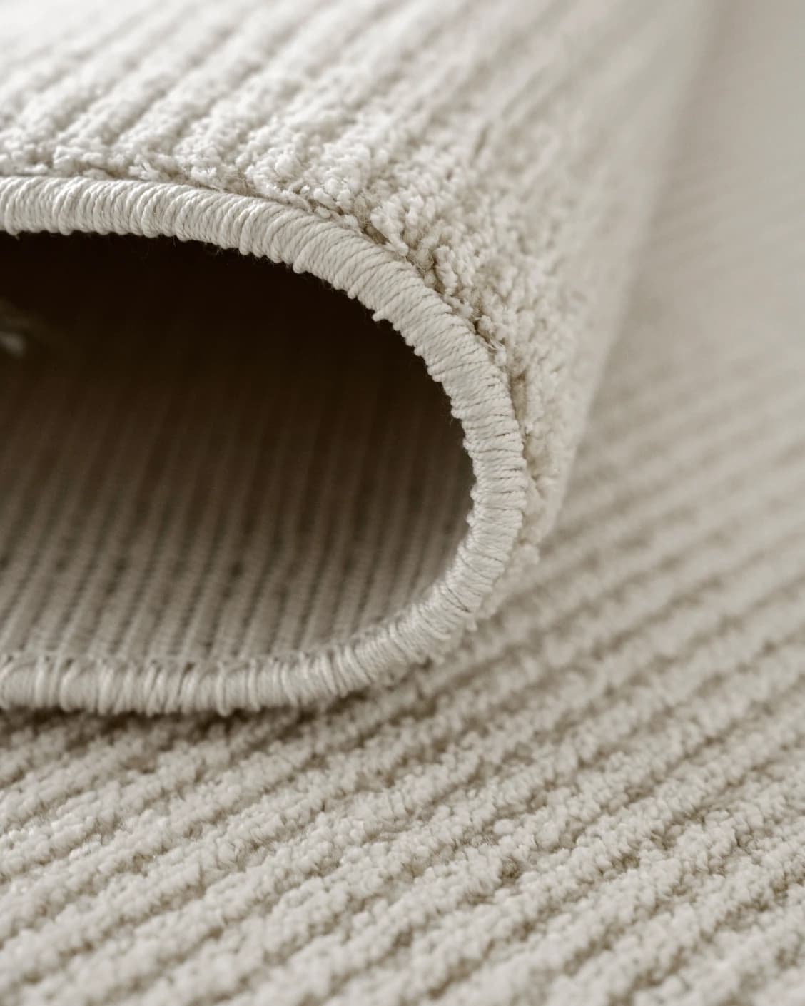 Rik Sandy carpet in beige, shown in a product close-up as image 6