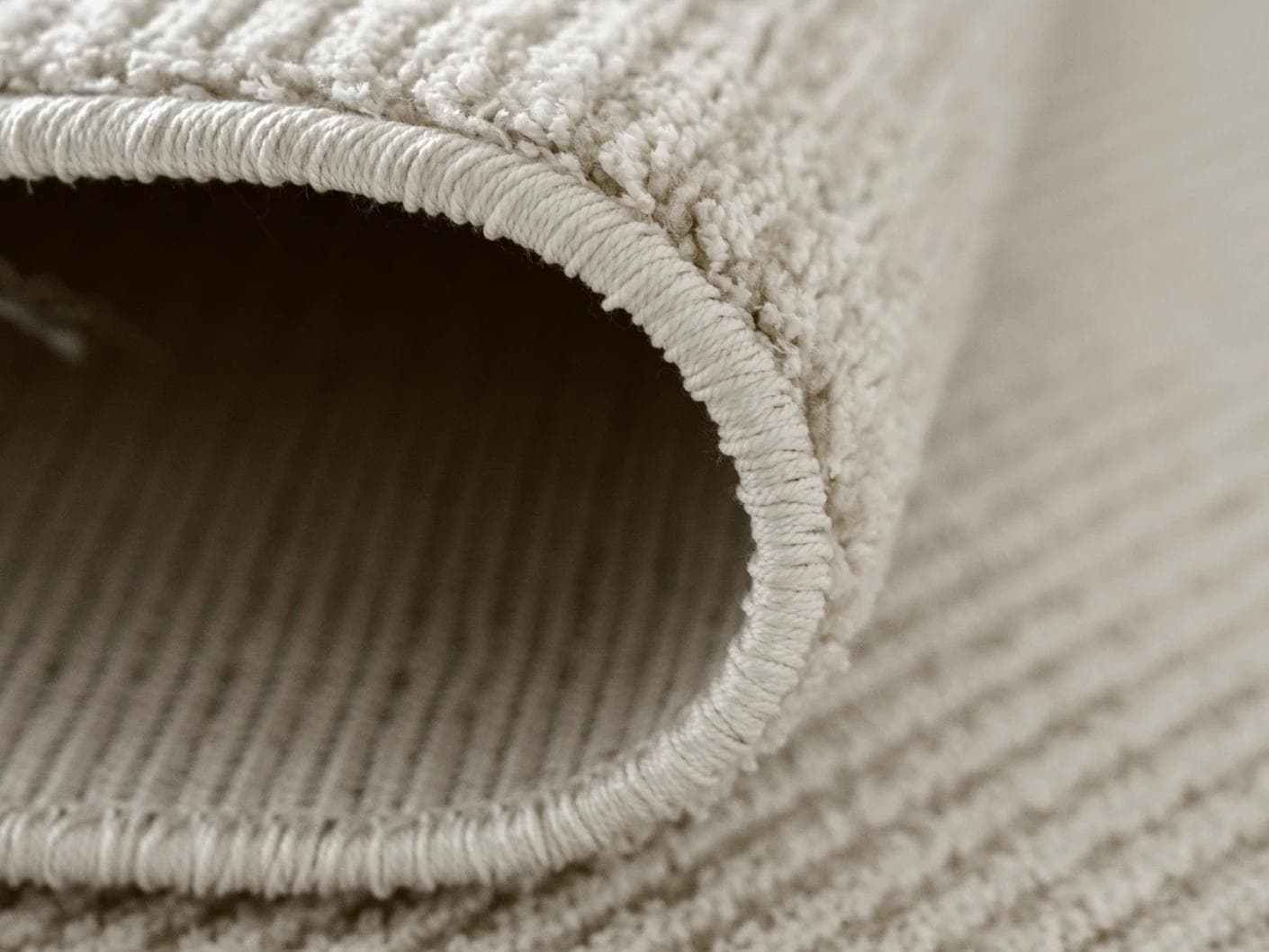 Rik Sandy carpet in beige, shown in a product close-up as image 6