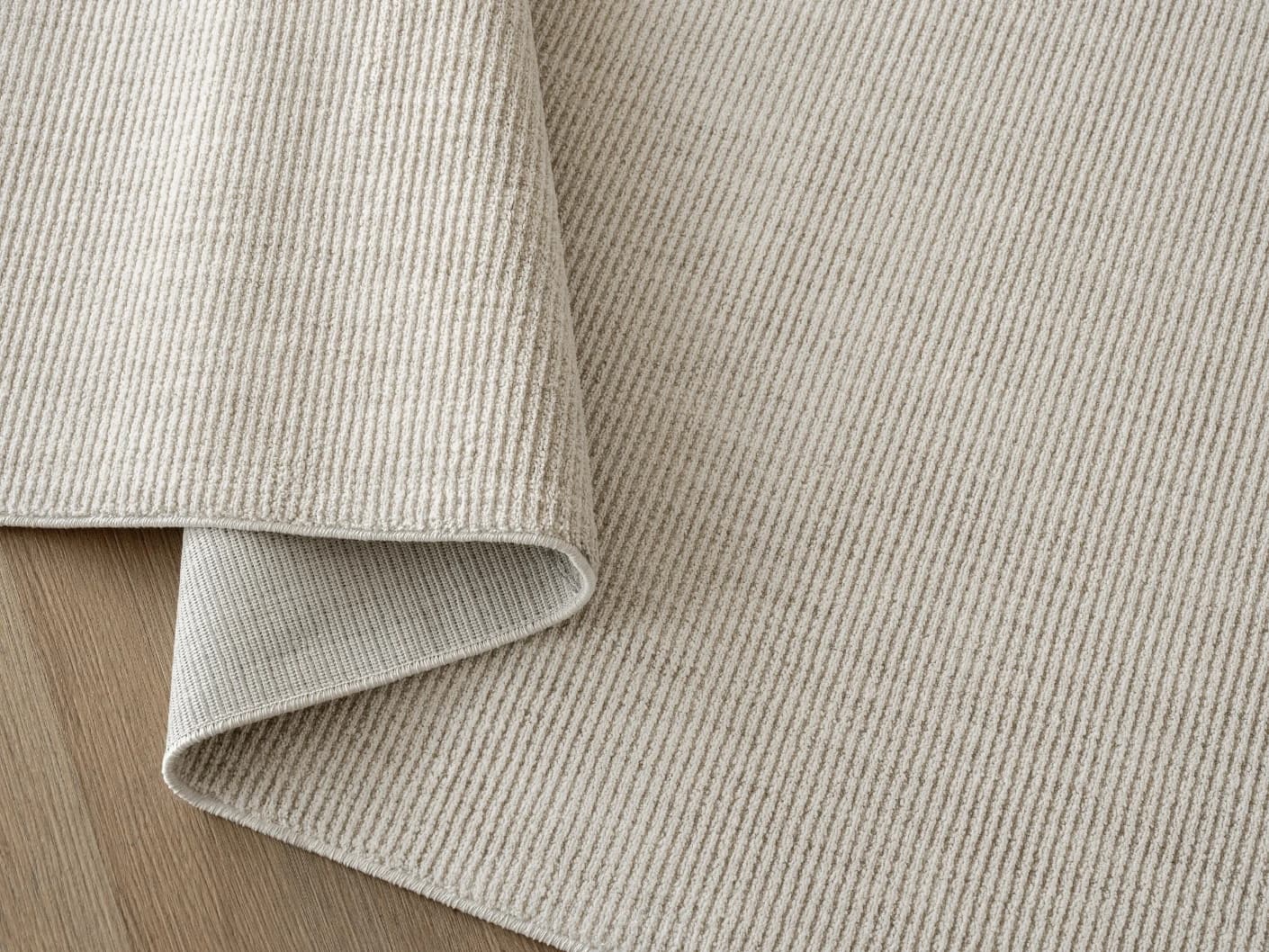 Rik Sandy Round carpets in sandy and beige, shown in a product close-up top view