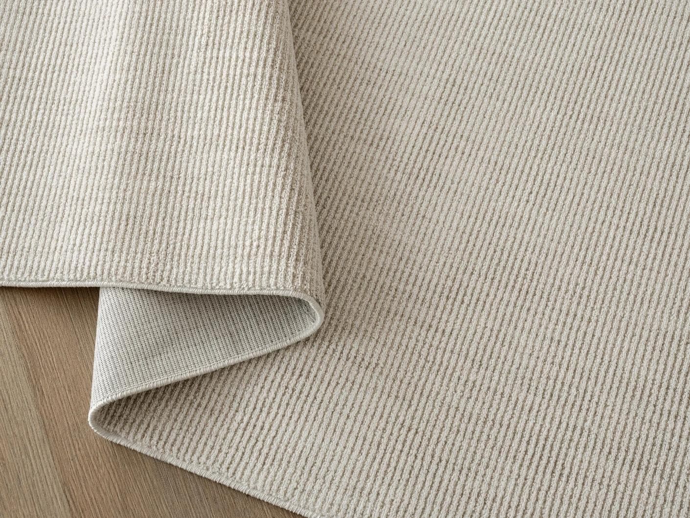 Rik Sandy carpet in beige, shown in a product close-up top view as image 8