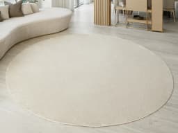 Rik Sandy Round carpet in beige, shown in a lifestyle front view