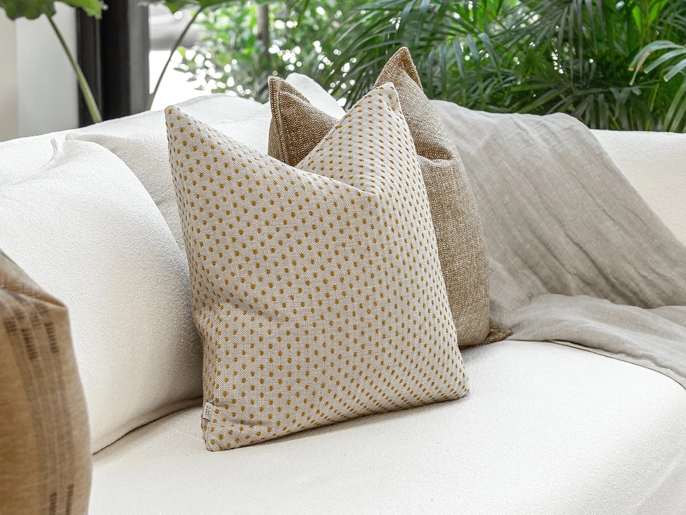 Romi Bundle bundle cushions in brown and beige, shown in a lifestyle front view