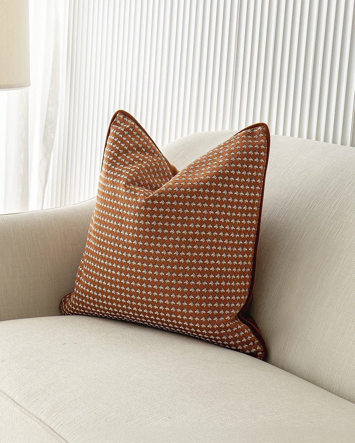 Rory Caravaggio cushion in orange, shown in a lifestyle front view as image 2