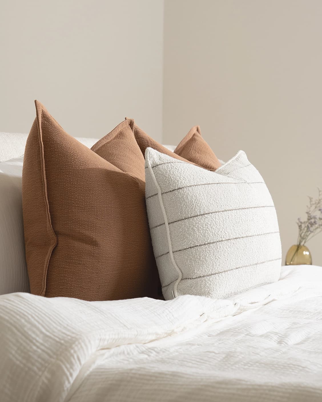 Rosh Bundle cushion in rust and ivory, shown in a lifestyle left view as image 6